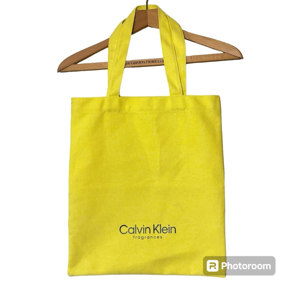 NWOT Calvin’s Klein Fragrances lemon yellow canvas tote bag.